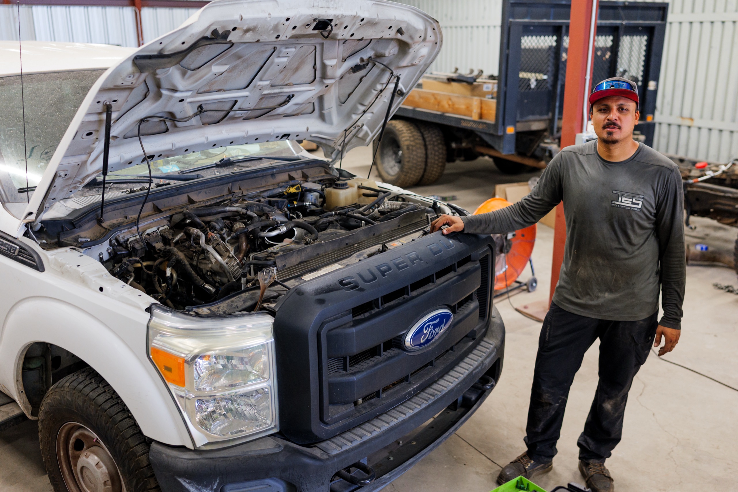 TES technician beside a Ford Super Duty at the Phoenix shop